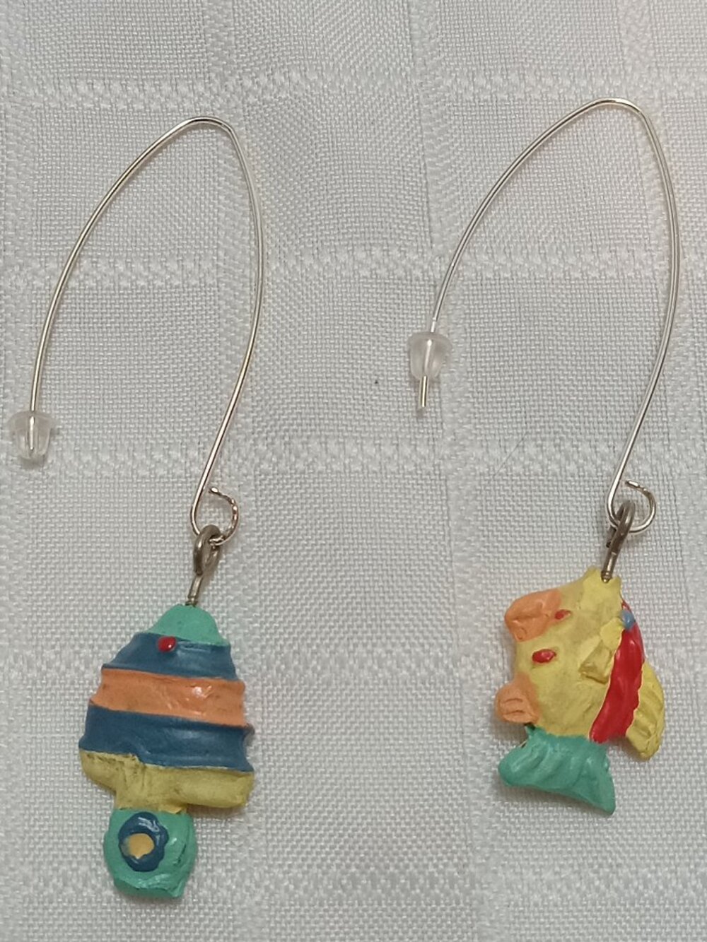 Handmade earrings featuring small, colorful fish